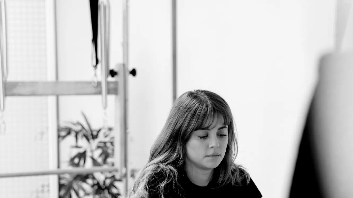 Woman working on a Pilates reformer